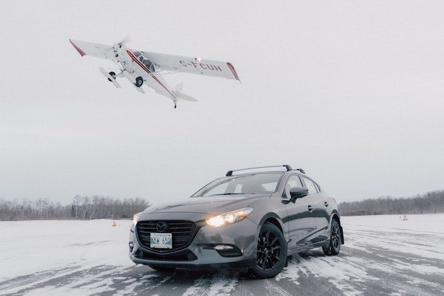 three line tales, week 266: a plane taking off with a car on the snowy runway