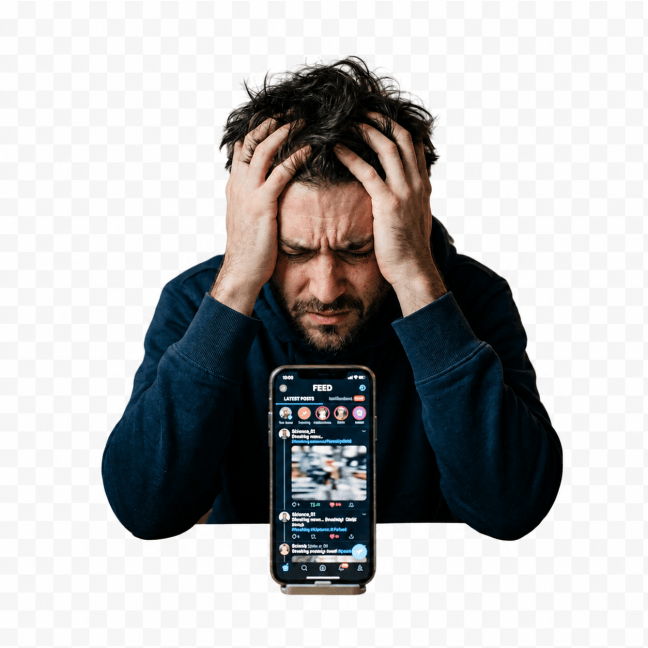 Stressed man gripping his head behind a smartphone showing a social media feed