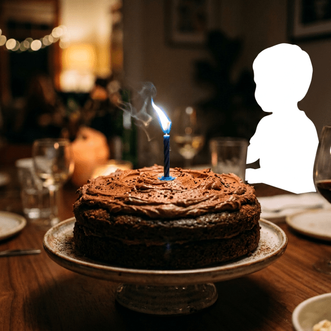 Chocolate cake with a lit blue candle on a dining table